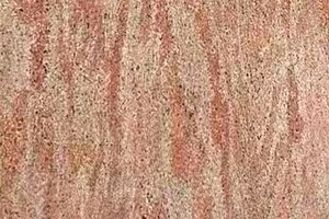 A pink granite with linear movement and subtle tonal variation.