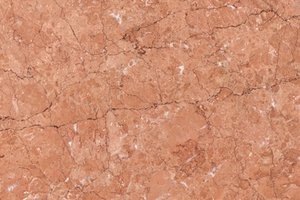 A coral-red marble with soft tonal variation and fine white veining.