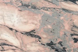 A pink marble with bold black and gray movement.