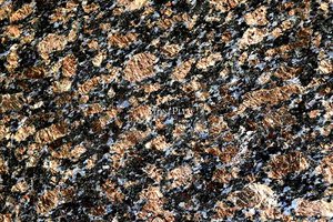 A coarse grained, blue and brown granite with grey and beige flecks.