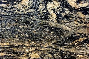 A gold and black granite with a veined texture.