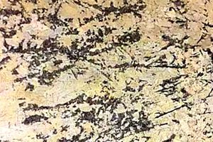 A yellow and black granite with a combination of beiges, creams, browns and blues.