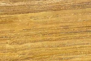 A golden-brown travertine with linear banding and layered texture.