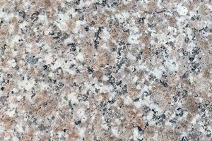 A pink and light gray granite with fine, evenly distributed black and white speckling.