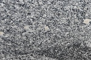 A medium gray granite with fine black and white speckling and soft, flowing movement.