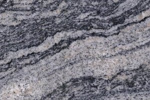 A gray granite with flowing bands of black and white veining.