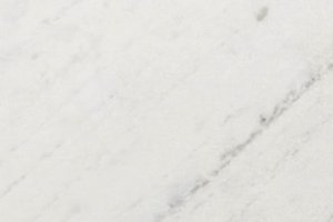 A white marble with fine gray veining and soft directional movement.