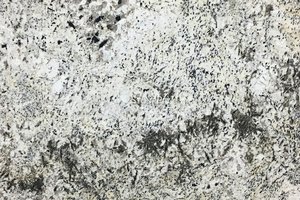 A white granite with flecks of brown and black veining.