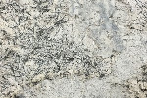 A white granite with tan variation and sharp black veining.