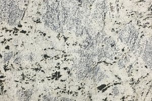 A white granite with black specks and thin veining