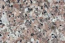 A red granite with grey and black spots.