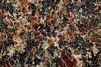A coarse grained granite with varying shades of brown and black.