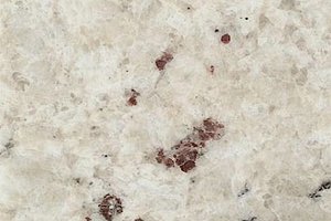 A mostly white granite with burgundy flecks.