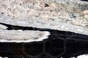 A black granite with white veins.