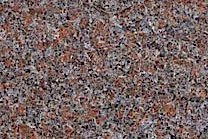 A low variation granite with red, grey, brown and black colors.