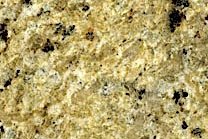 A gold granite with black and beige colors in a spotted pattern.
