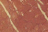 A red marble with white veins.