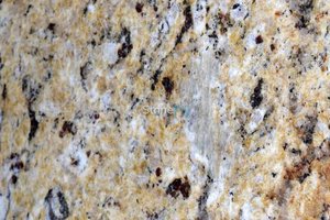 A gold granite with dark accents.