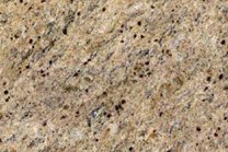 A coarse grained, beige granite with gold and grey veins.