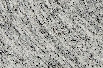 A fine grained, grey and white granite with veins.