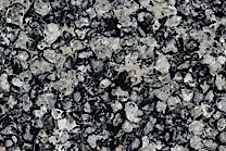 A black granite spoted with dark grey, brown and silver.