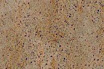 A yellow and brown granite with black dots.